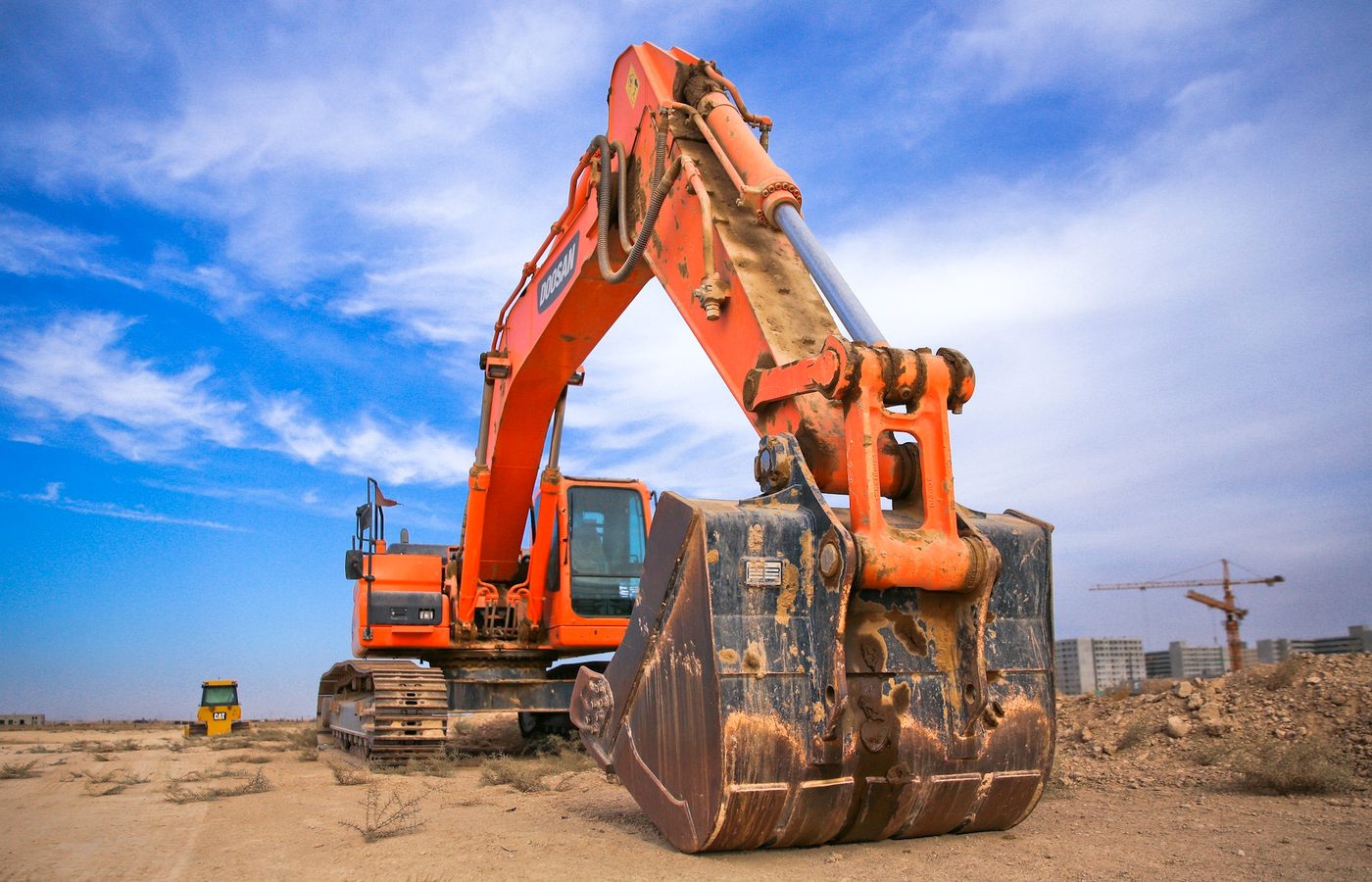 Excavator for industrial concrete demolition and pad preparation in Terrell TX
